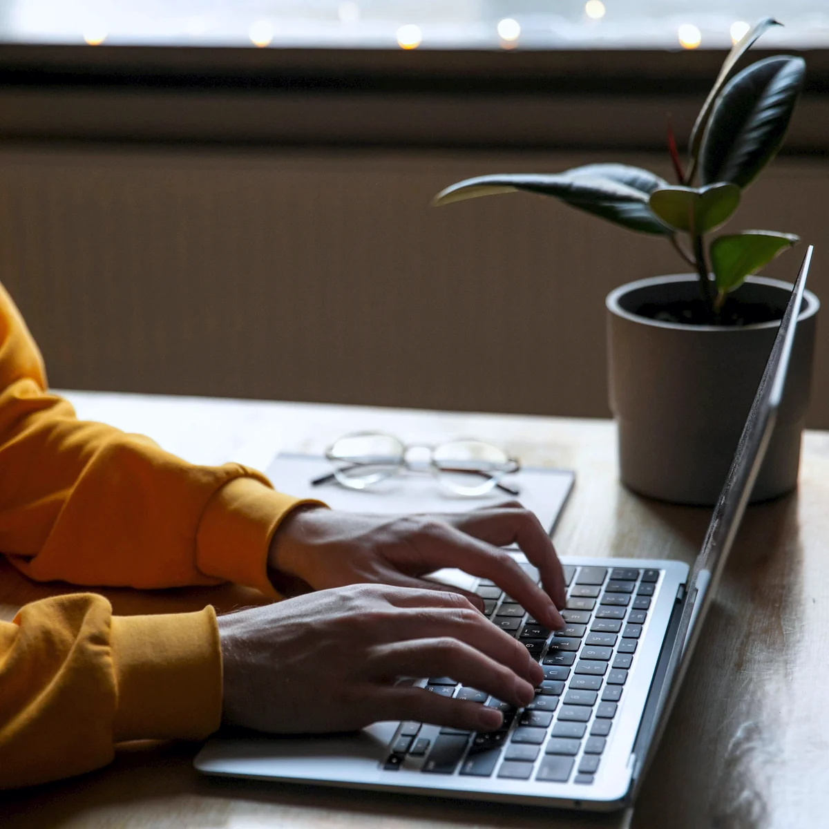 Hands writing an email on a laptop